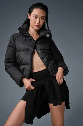 Black puffer jacket with a quilted design and hood.