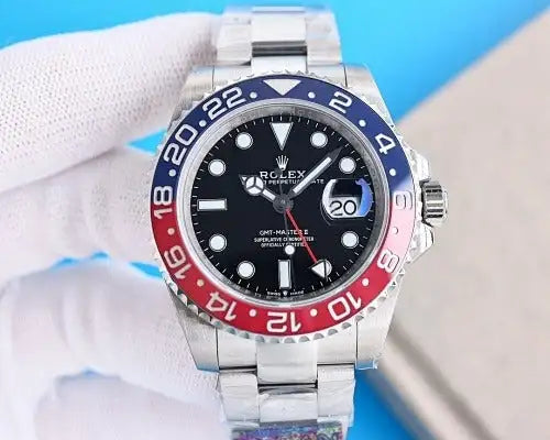 Silver stainless steel rolex gmt-master ii watch with a black dial, red and blue bezel, and date window at the 3 o’clock position.